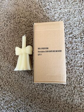New in Bow.  Small Ivory Bow Shaped Candle
